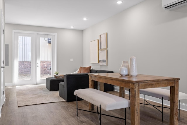 dining area featuring recessed lighting, wood finished floors, and a wall mounted AC