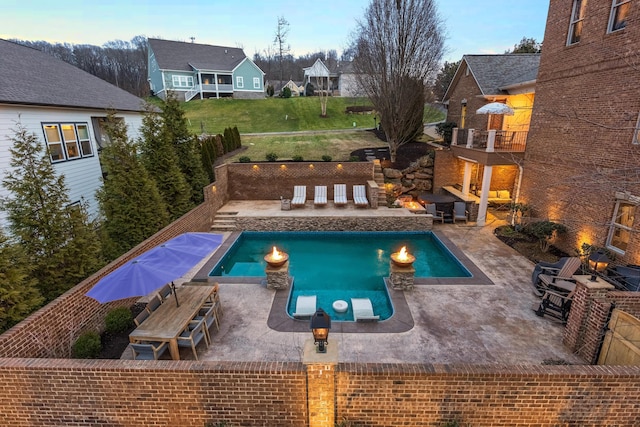 pool featuring a fenced backyard and a patio