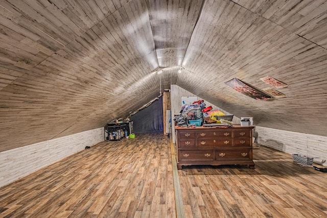 bonus room featuring wood ceiling, wood walls, wood-type flooring, and vaulted ceiling