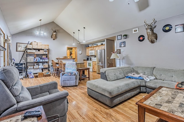 living area featuring lofted ceiling and light wood-style floors