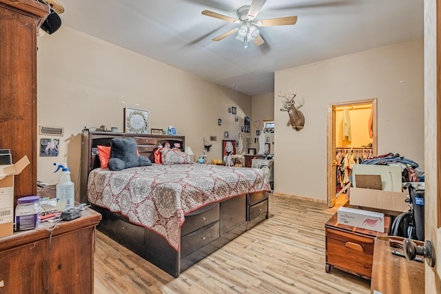 bedroom with light wood finished floors and ceiling fan