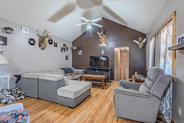 living room with ceiling fan, visible vents, vaulted ceiling, and wood finished floors