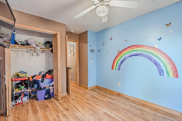 game room with ceiling fan, baseboards, and wood finished floors