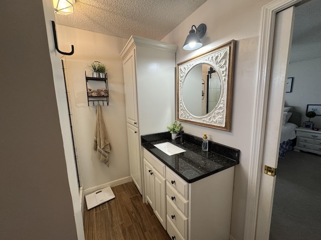 1164 Harvest Glen Dr NW, Cleveland, TN 37312 - bathroom with vanity, a textured ceiling, wood finished floors, and baseboards