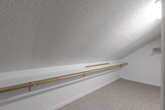 spacious closet with carpet and vaulted ceiling