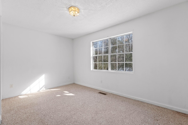 unfurnished room featuring carpet floors and a textured ceiling