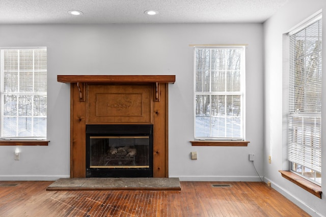 room details with a textured ceiling and hardwood / wood-style flooring