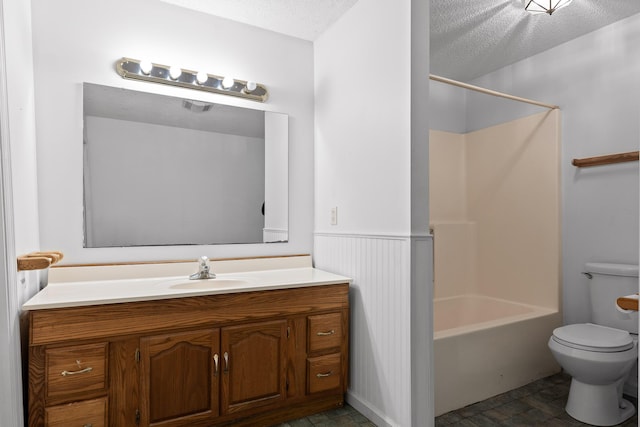 full bathroom with toilet, vanity, a textured ceiling, and shower / tub combination