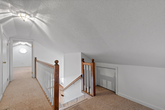 bonus room with light colored carpet, vaulted ceiling, and a textured ceiling