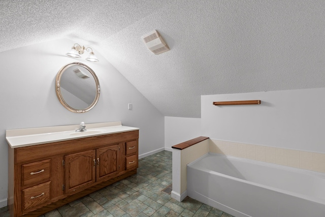 bathroom with a tub, lofted ceiling, and vanity