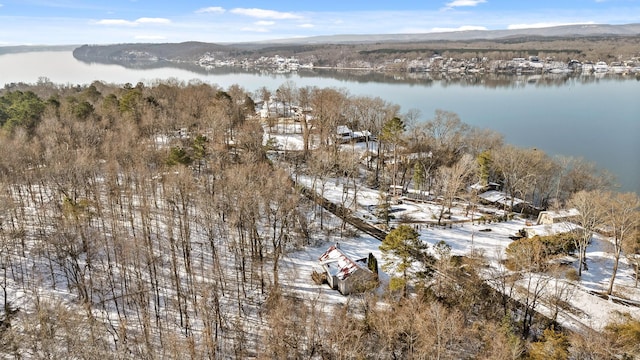 snowy aerial view with a water and mountain view