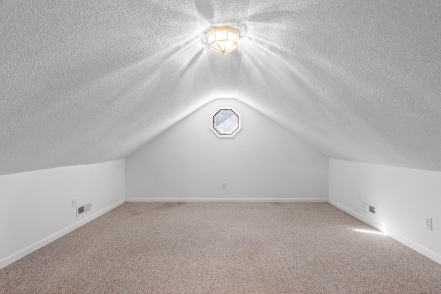 additional living space featuring lofted ceiling and carpet