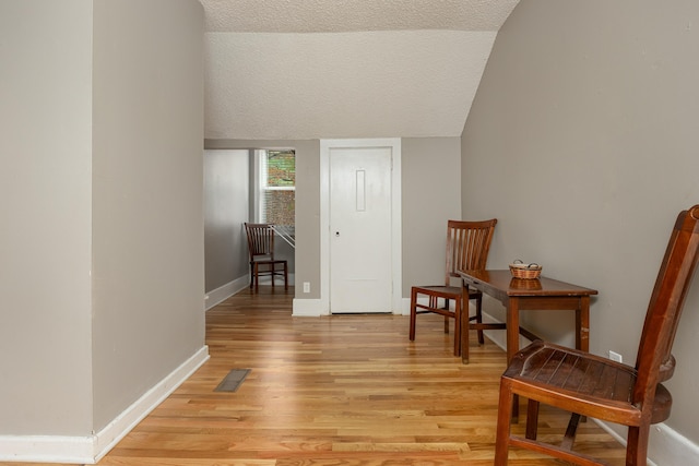 sitting room with light hardwood / wood-style flooring and a textured ceiling