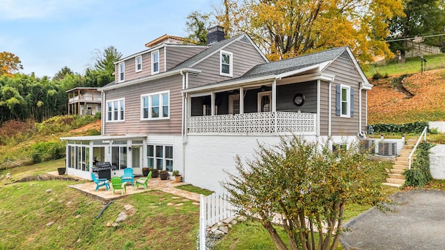 back of house with a patio, a sunroom, and central air condition unit