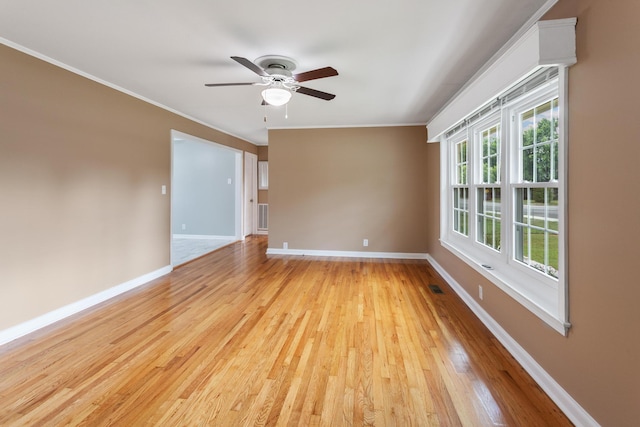 unfurnished room with light hardwood / wood-style flooring, ceiling fan, and ornamental molding