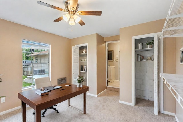 carpeted home office with ceiling fan