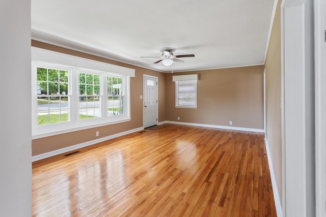 unfurnished room with crown molding, light hardwood / wood-style flooring, and ceiling fan