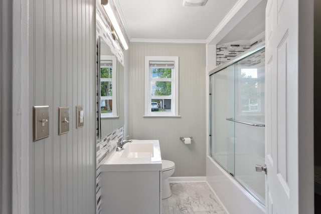 full bathroom featuring combined bath / shower with glass door, vanity, toilet, and crown molding