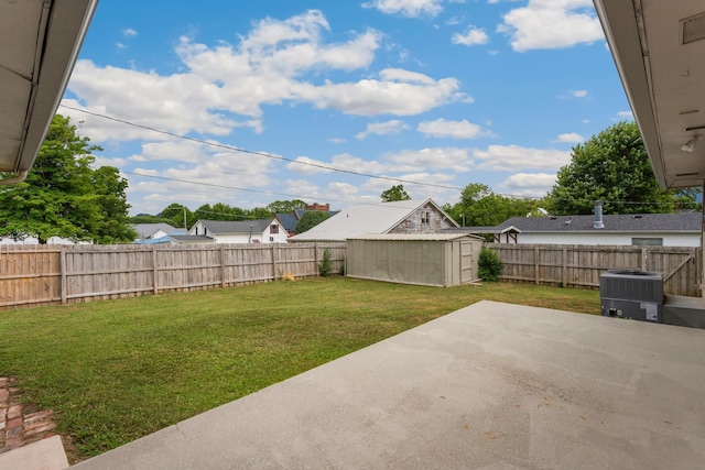 view of yard with cooling unit, a patio, and a storage shed