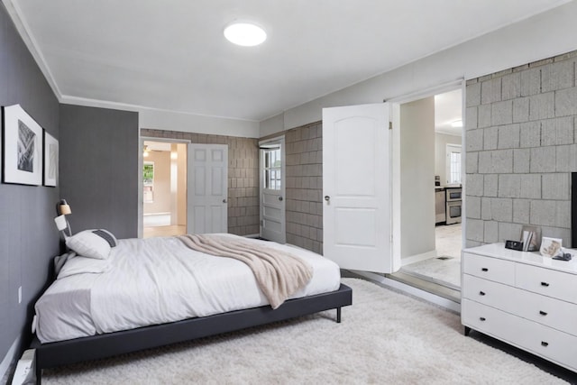 bedroom with ensuite bathroom and ornamental molding