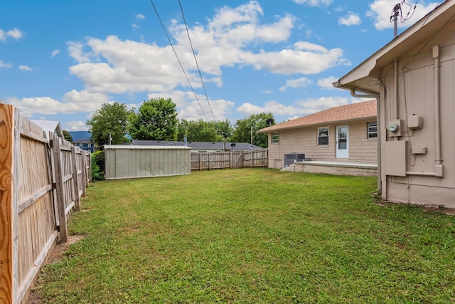 view of yard featuring central air condition unit and a shed