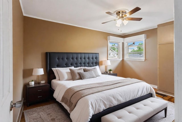 bedroom with ceiling fan, light hardwood / wood-style floors, and ornamental molding