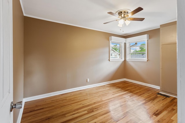 empty room featuring light hardwood / wood-style flooring, ceiling fan, and ornamental molding