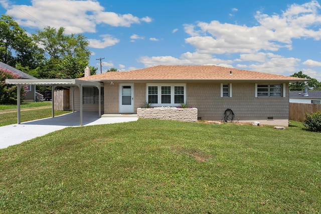 back of property featuring a carport and a yard