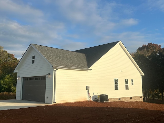 view of side of home with central AC