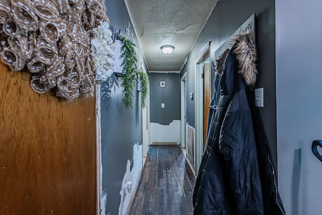 hallway featuring a textured ceiling and dark wood-type flooring