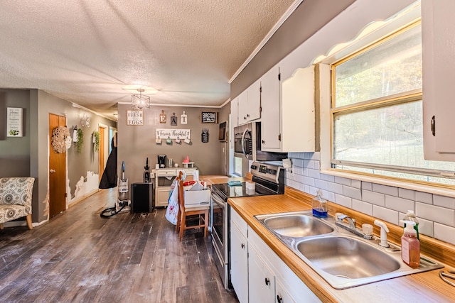 kitchen featuring white cabinets, sink, a textured ceiling, dark hardwood / wood-style flooring, and stainless steel appliances