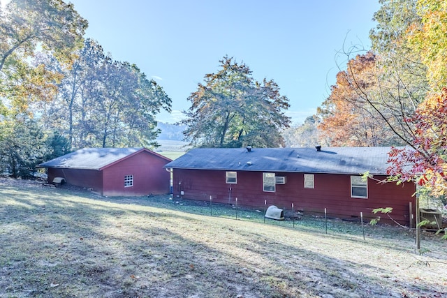 rear view of property featuring a yard and central AC