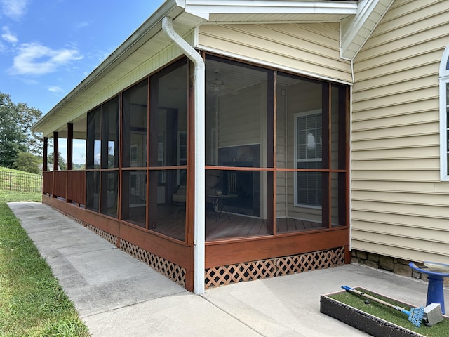 view of property exterior with a sunroom