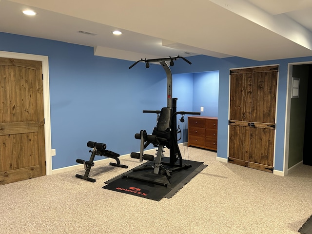 exercise room with light carpet