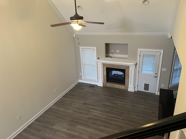 unfurnished living room with a fireplace, dark hardwood / wood-style floors, ceiling fan, and ornamental molding