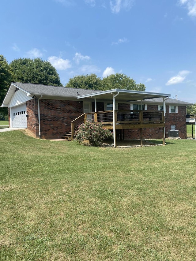 ranch-style home featuring central AC unit, a garage, a front lawn, and a deck