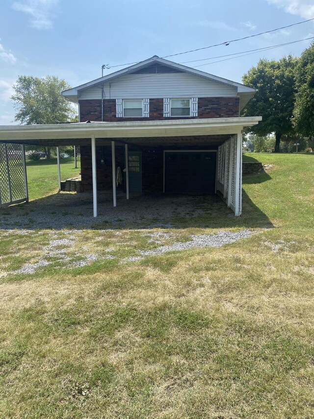 exterior space with a carport and a lawn