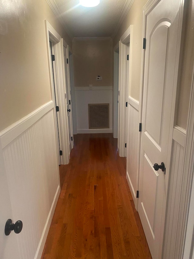 hall featuring wood-type flooring and ornamental molding