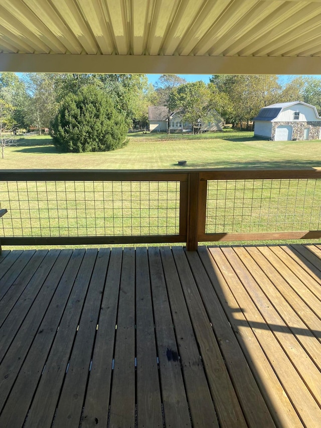 wooden terrace featuring a lawn