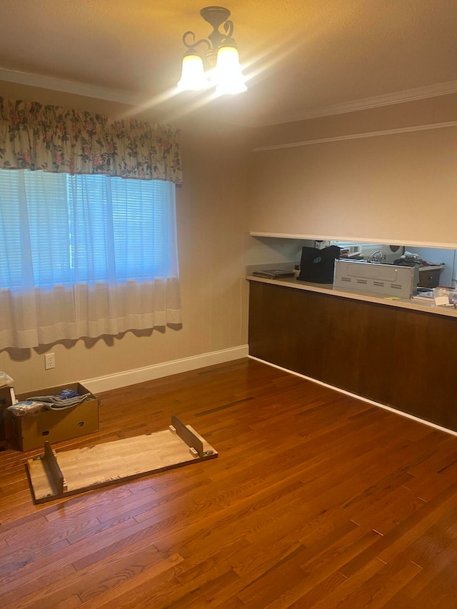 interior space featuring wood-type flooring and ornamental molding