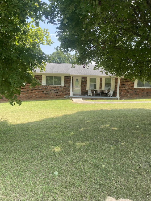 view of front of house with covered porch and a front yard