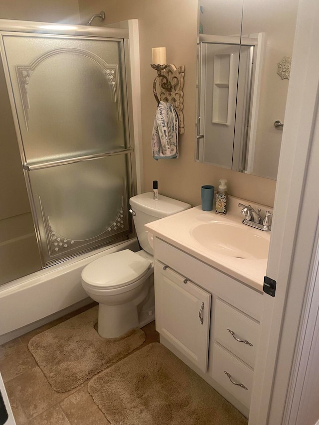 full bathroom with toilet, vanity, and combined bath / shower with glass door