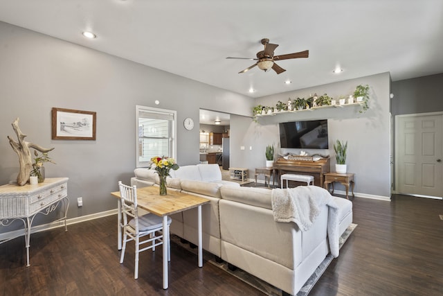 living room featuring dark hardwood / wood-style flooring and ceiling fan