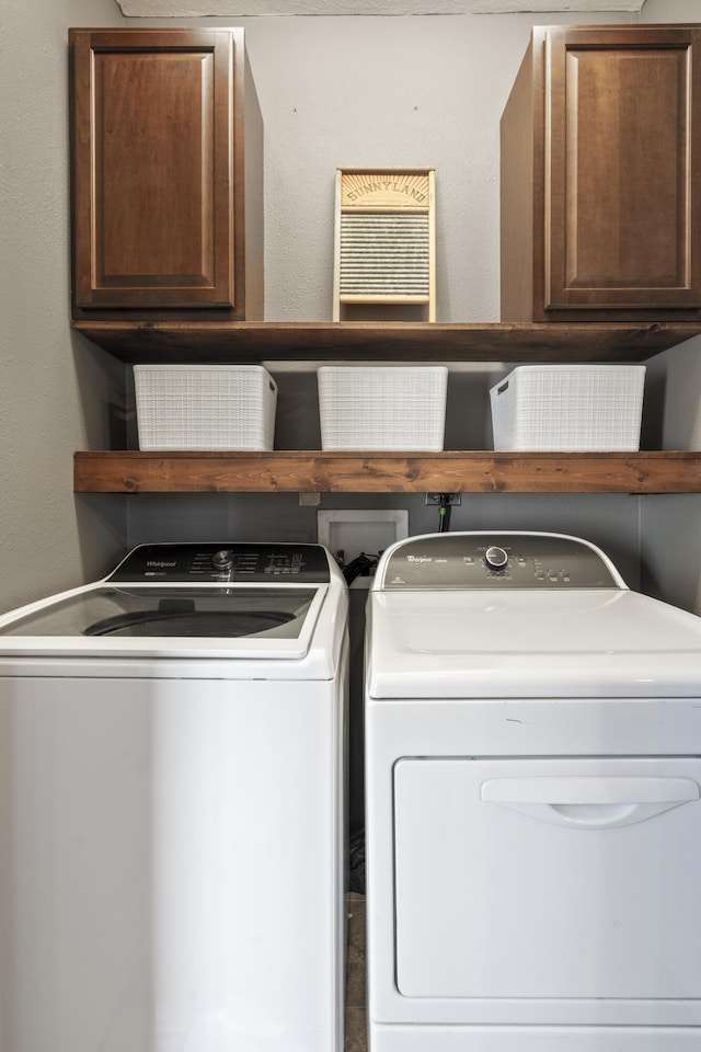 laundry room with cabinets and washer and clothes dryer