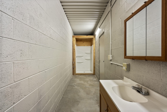 bathroom featuring vanity and concrete flooring