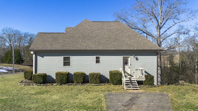 back of house with a lawn