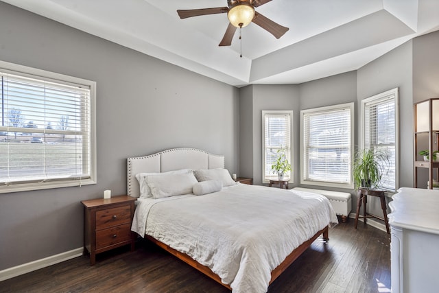 bedroom with dark hardwood / wood-style floors and ceiling fan