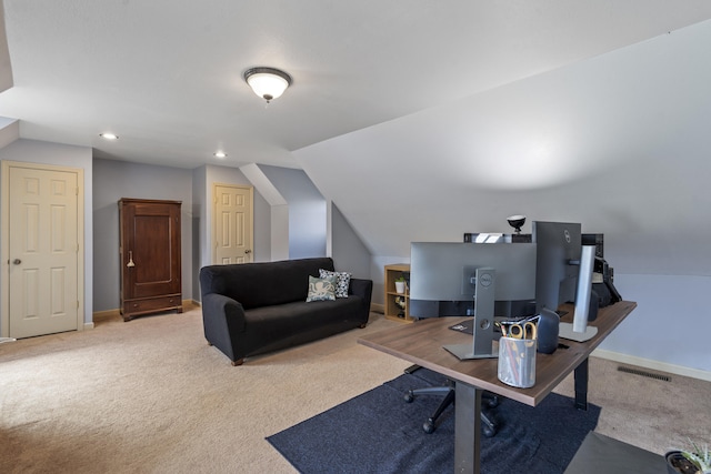 carpeted office with lofted ceiling