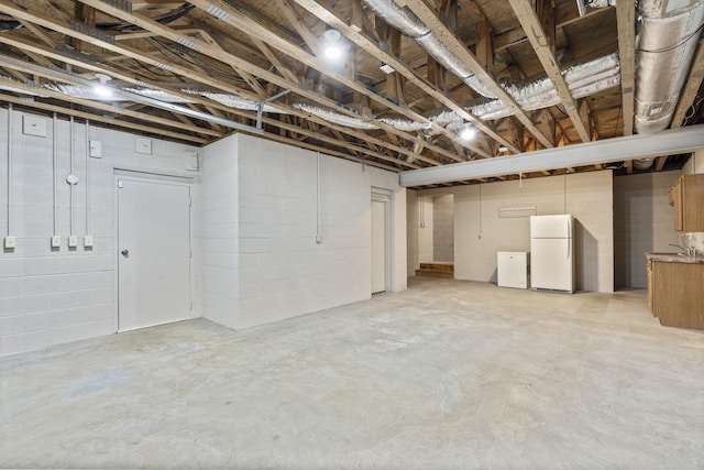 basement featuring white fridge