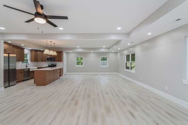 826 Long Mill Rd, Athens, TN 37303 - kitchen featuring appliances with stainless steel finishes, open floor plan, a kitchen island, light countertops, and decorative backsplash